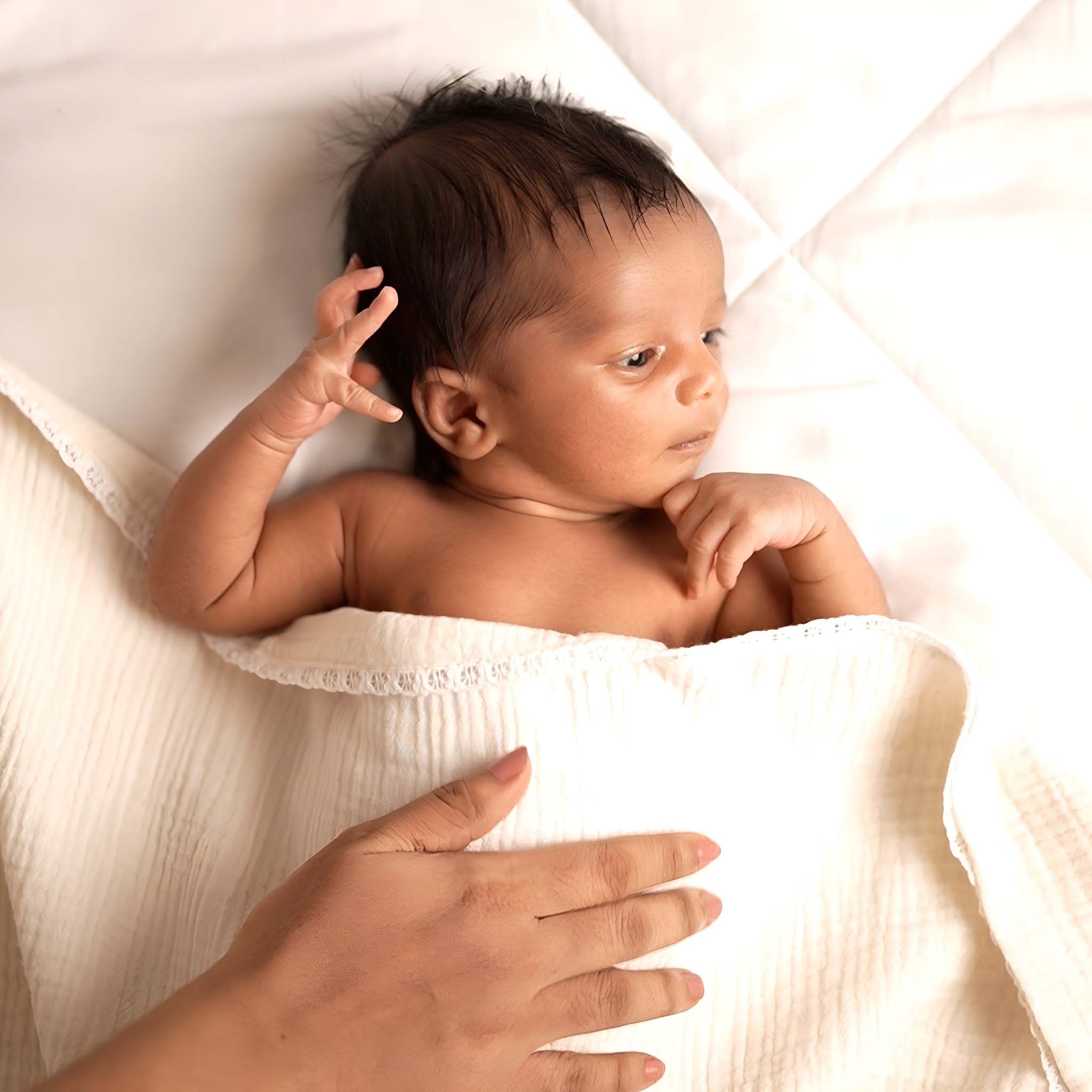 Newborn wrapped in Z-KIDS muslin swaddle blanket — ideal baby blanket for swaddling and warmth